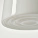 Close-up of a white lampshade with concentric circular design on a light gray background