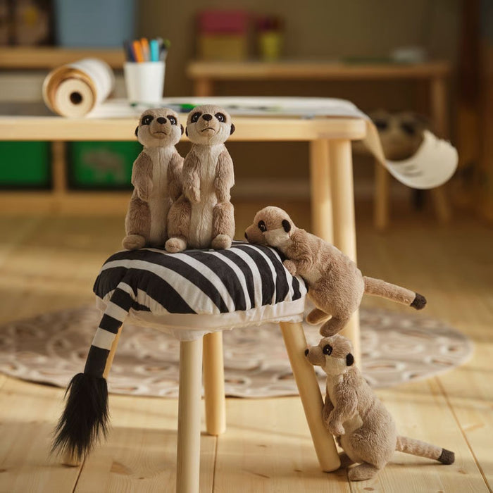 Two IKEA SANDLÖPARE covers with gathered edges and bold stripes, placed on light wooden stools in cozy indoor setting