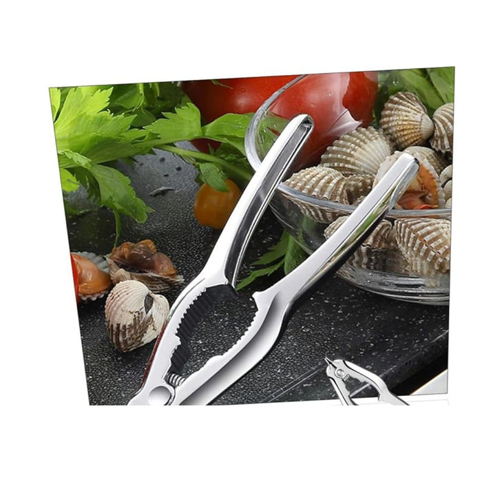 Metallic kitchen tongs on a background of vegetables and shellfish
