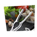 Metallic kitchen tongs on a background of vegetables and shellfish