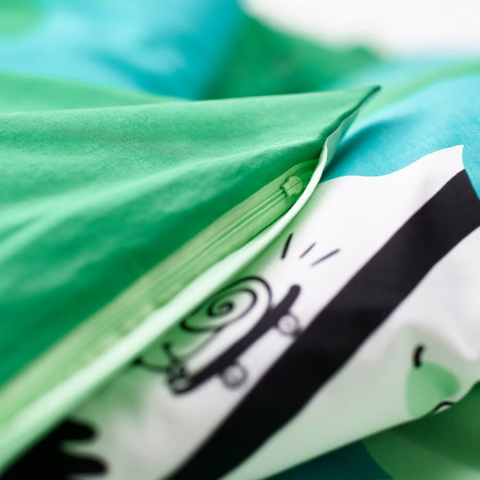 Close-up of green fabric with a black and white design on a blurred background