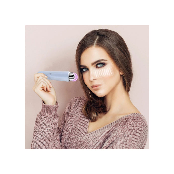 Woman holding a cosmetic product against a plain background