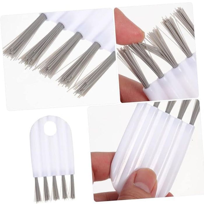 Set of metal bristle brushes with white handles, held by a hand.