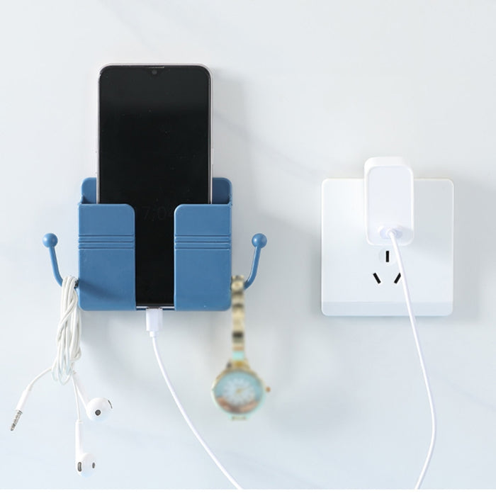 Blue wall-mounted charging stand with smartphone placed inside; side hooks hold a white earphone cable and a black wristwatch—connected to a wall socket with a charging cable, showcasing organized multi-use storage – 1598448185067 13069398.