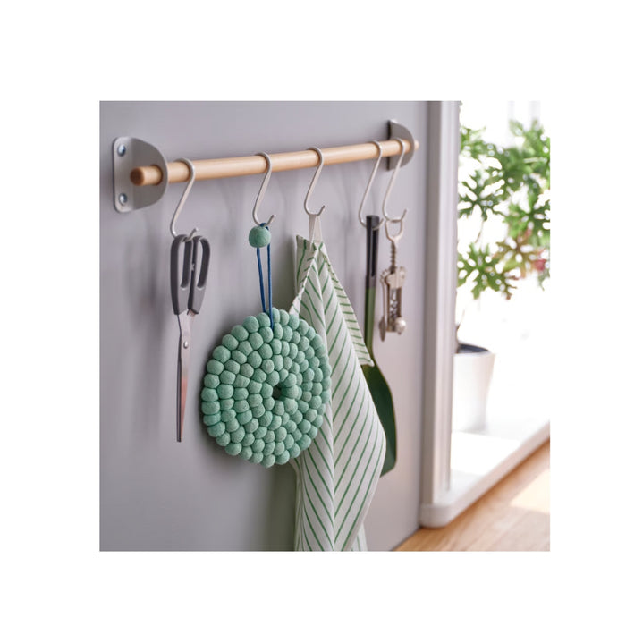 Wall-mounted metal rod with hooks holding kitchen items against a light gray wall.