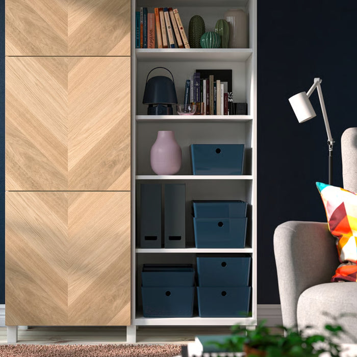 Living room shelving unit with multiple KUGGIS boxes in use for organizing books, binders, and decor items