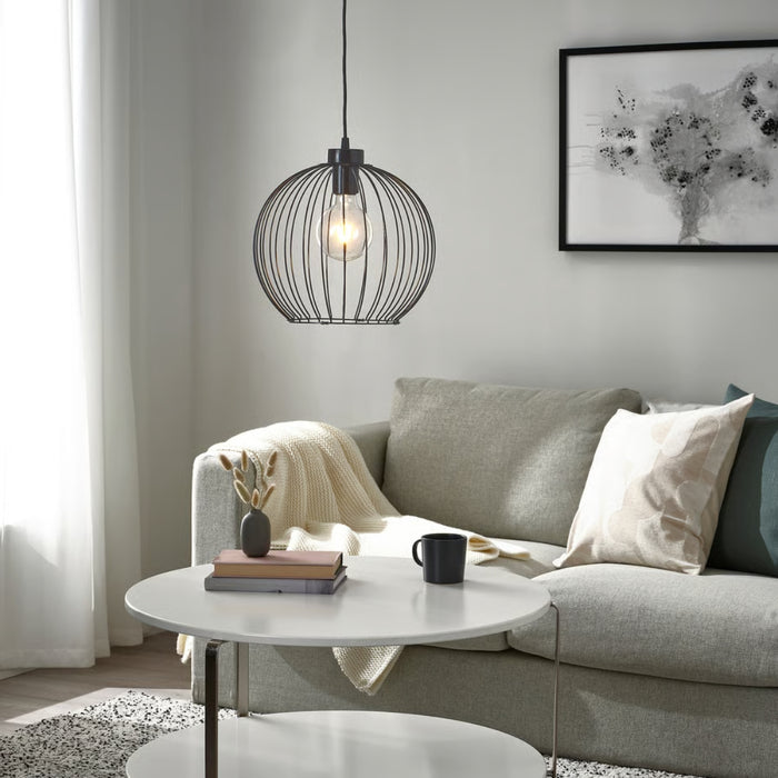 Modern living room with a gray sofa, round coffee table, and decorative elements.
