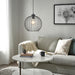 Modern living room with a gray sofa, round coffee table, and decorative elements.