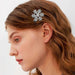 Crystal snowflake hair clip – side profile with wavy brown hair and sparkling silver snowflake accessory