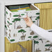 Hand opening a patterned storage box with animal designs.