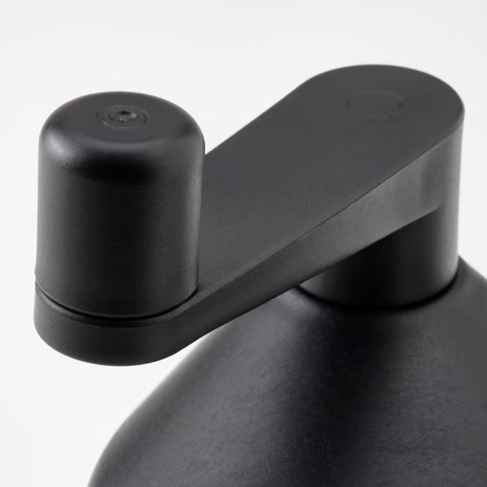 Close-up of STENSNULTRA lid and handle component in modern black design with cylindrical cap and elongated arm