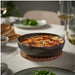 Rustic kitchen scene with GLADELIG bowl holding ricotta gnocchi in tomato sauce, surrounded by fresh ingredients and cheese-70607948