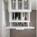 Kitchen drawer organizer with cutlery and spices in a modern kitchen setting.