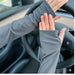 Close-up of hands in textured gray sleeves with thumb loops, designed for extended wear and UV shielding