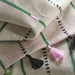 IKEA MÄVINN Table-runner, off-white with green, pink, and black stripes – hand-embroidered detail with tassels adds artisanal flair – 35x130 cm – 40601622