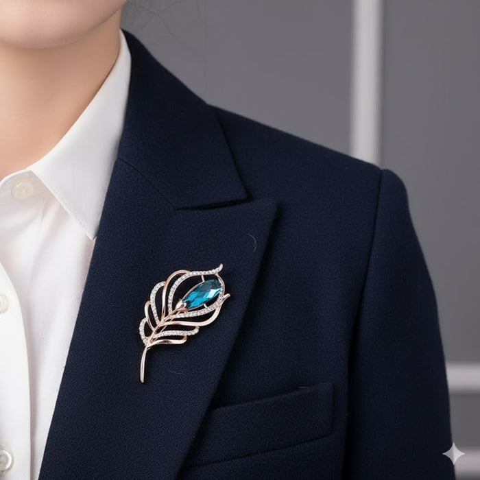 worn on blazer with white shirt, highlighting blue crystal centerpiece