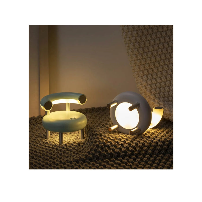 Two modern table lamps on a textured surface with a neutral background