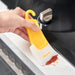 Hand scraping red residue off white countertop using yellow and white cleaning tool – 1598449174494 14075321