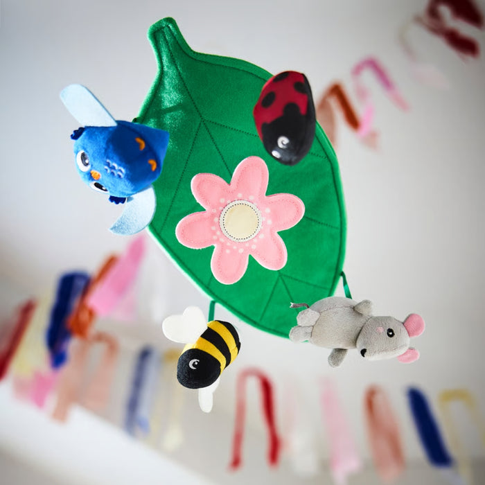 SANDBI mobile styled with ribbons and streamers, featuring plush owl, bee, ladybug, and mouse under green leaf canopy