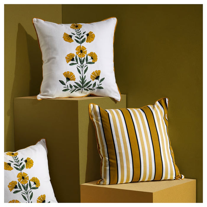 Decorative pillows with floral and striped patterns on a brown background