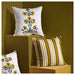 Decorative pillows with floral and striped patterns on a brown background