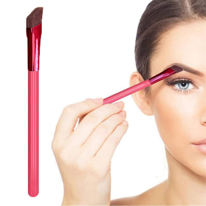 Woman using red angled eyebrow brush for precise shaping – close-up highlights slanted bristles and ergonomic grip – 1598453751840 14041847
