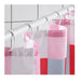 Checkered shower curtain with pink, white, and red pattern on a tiled wall background