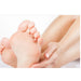 Close-up of a baby's feet with an adult hand gently holding them on a white background