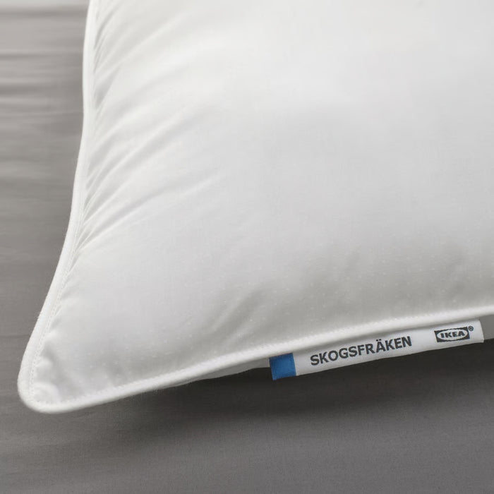 White pillow with IKEA label on a gray background