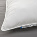 White pillow with IKEA label on a gray background