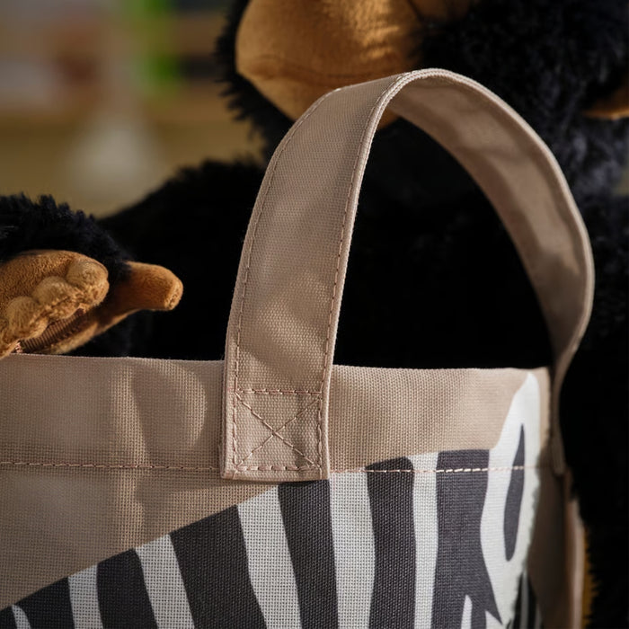 IKEA SANDLÖPARE storage bag – zebra-themed storage bin with plush bear toy, shown in cozy playroom corner – 50603215