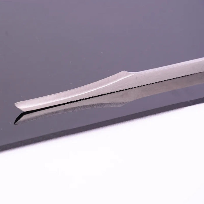 Digital Shoppy manicure spatula – close-up of scalpel-style blade on reflective surface for precision trimming