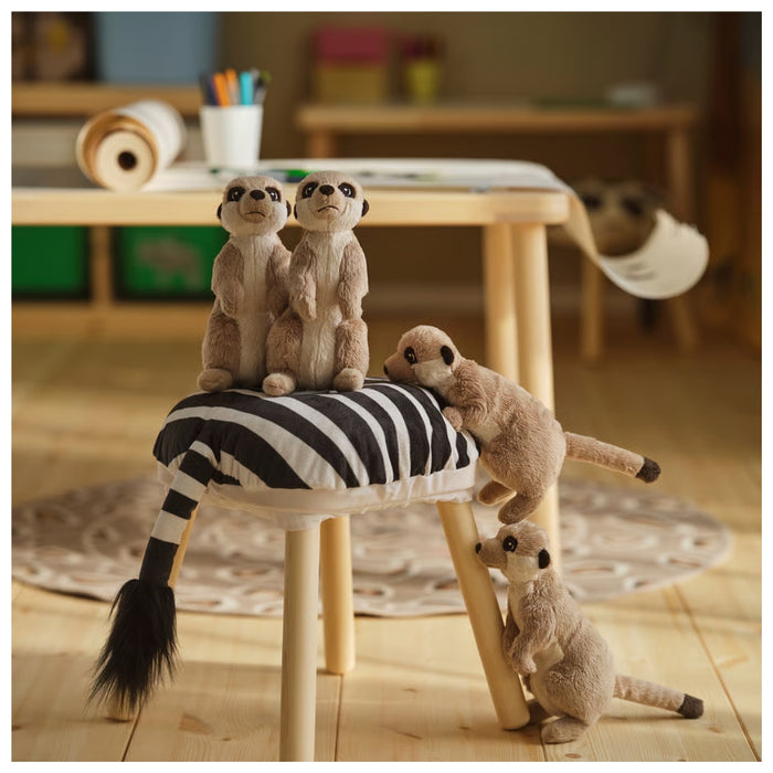 Plush meerkats on a striped stool in a room setting