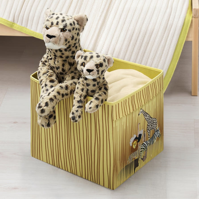 Toy storage box with plush leopards on a light wooden floor.