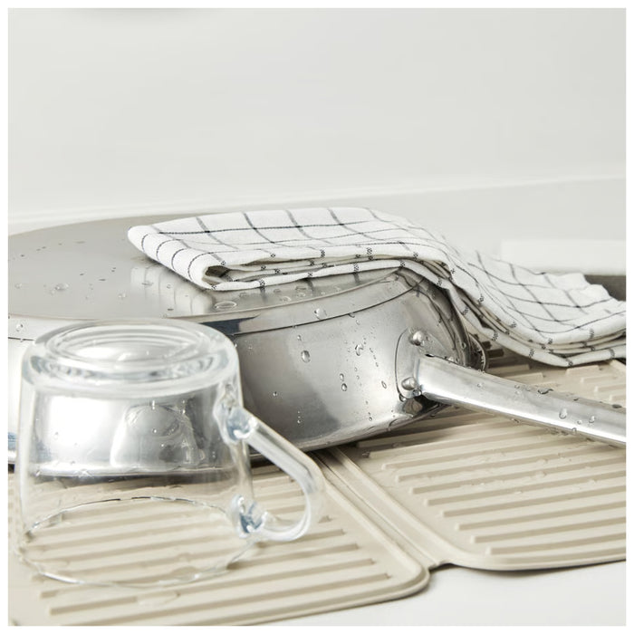 Clear glass container with a lid on a textured surface with a white background