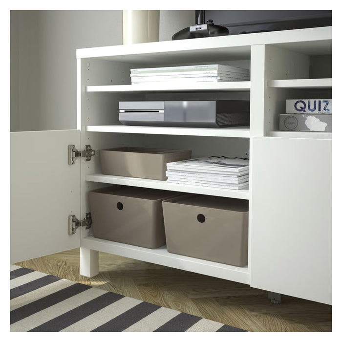 White storage cabinet with open door showing interior shelves and bins, on a striped floor.