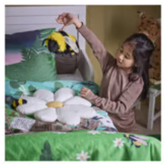 IKEA SKOGSDUVA soft toy – child holding bumblebee plush above flower pillow in nature-themed bedroom - 80576908


