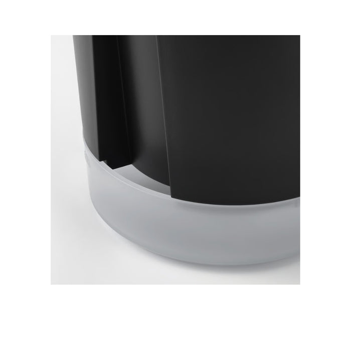 Side angle of VÅRDTRÄD 12 cm self-watering pot on patio table with decorative plants