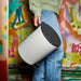 Person easily carrying the lightweight white and anthracite pedal bin by its back handle.