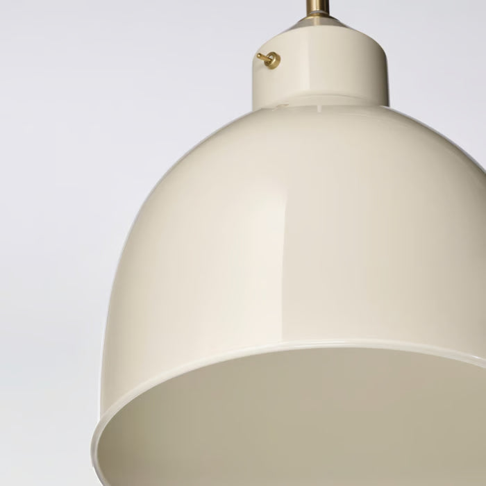 Close-up of the smooth, glossy light beige finish on the metal shade of the RÖDFLIK pendant lamp.