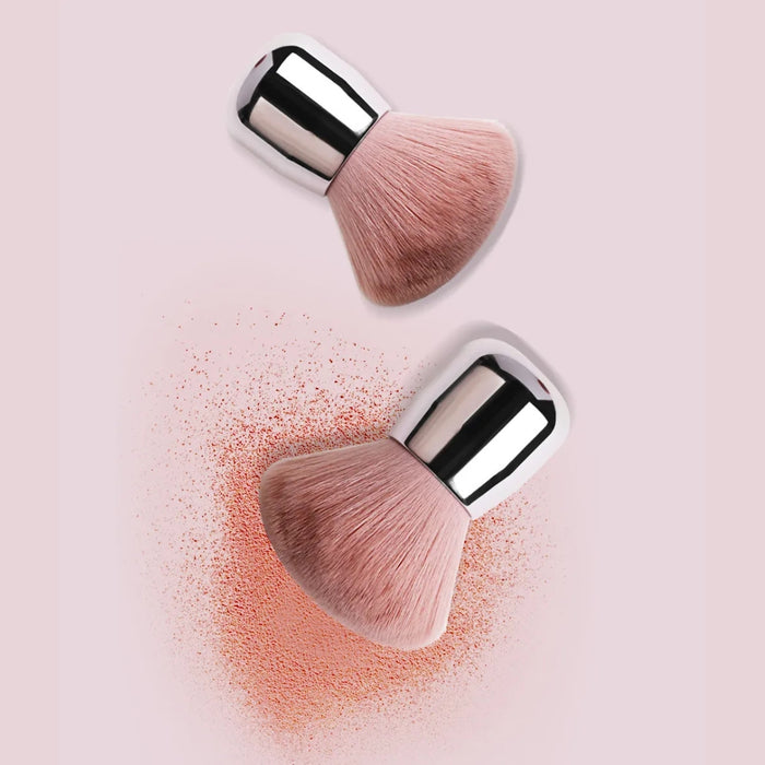 Makeup brush dispersing pink powder cloud against soft pink background