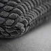  Detailed view of SVARTPOPPEL cushion cover with plush tufted dot pattern and visible zipper at edge for removable cover convenience