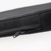 Detail view of STAGGSTARR zipper and stitching, revealing inner lining beneath durable black fabric