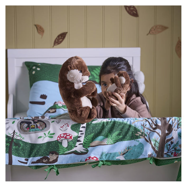IKEA SKOGSDUVA soft toy – child holding otter plush toys on nature-themed bedding with forest animals - 90576899

