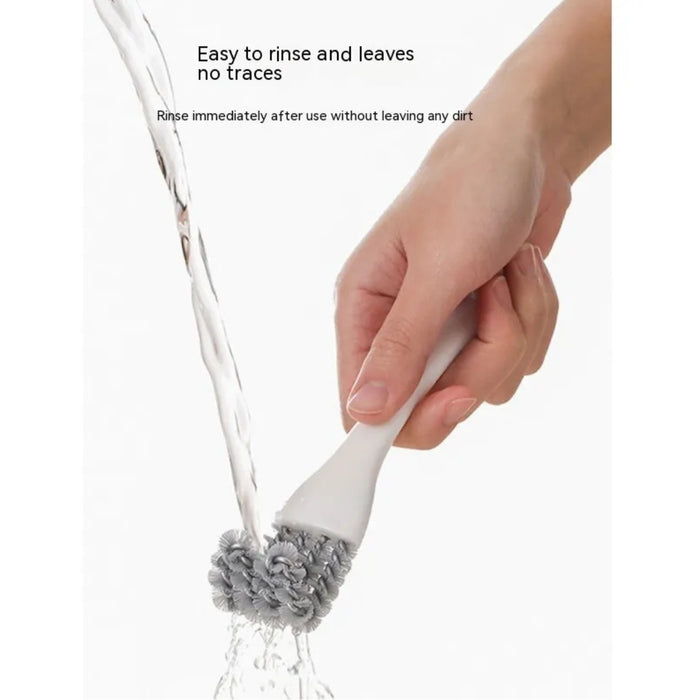 Digital Shoppy cleaning brush – white handle with gray bristles rinsed clean under running water