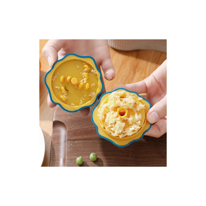 Two hands holding silicone food molds with yellow contents on a wooden surface.
