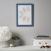 IKEA FISKBO frame in dark grey blue, 21x30 cm (8 ¼x11 ¾") placed on wall; displays split portrait of child’s photo and drawing – styled with white lamp, pen holder, toy car, and “HUGGET IS BEST” note for playful workspace decor - 20584930