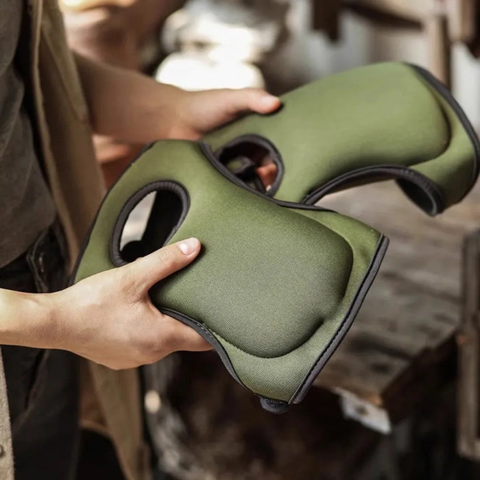 Person holding green knee pads with a blurred background