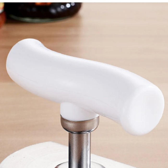 White kitchen tool handle on a beige background