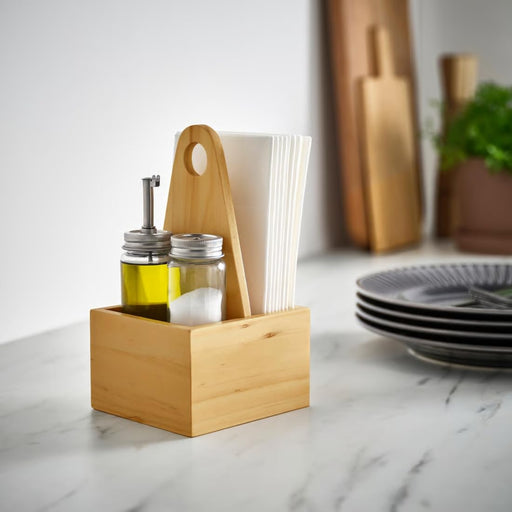 IKEA CHOKLADHAJ pine wood organiser holding oil bottles and napkins on marble kitchen countertop